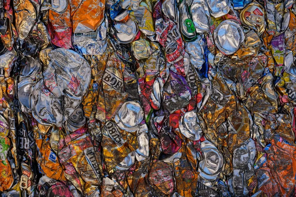 Crushed used aluminium cans in a recycling pile