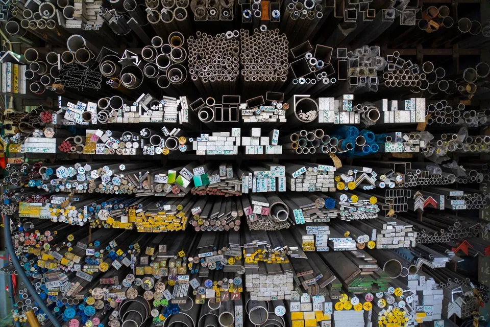 Stacks of metal pipes and rods in a warehouse